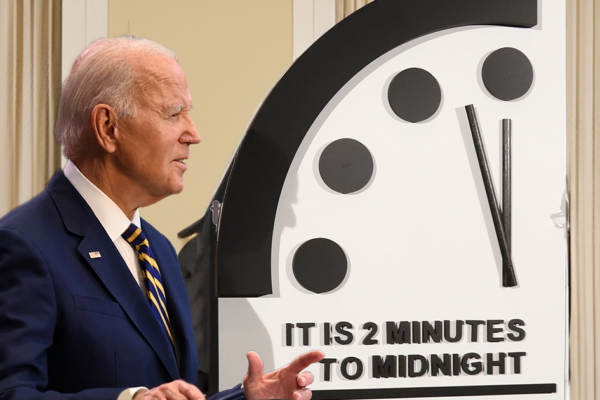 Joe Biden pictured in front of the doomsday clock