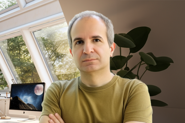 Father standing in home office in front of computer with moon on monitor