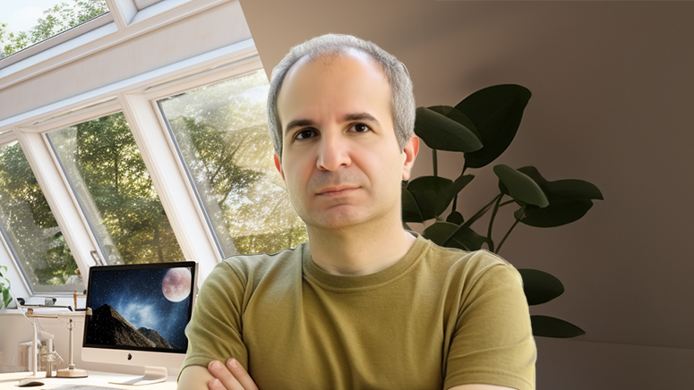 Father standing in home office in front of computer with moon on monitor