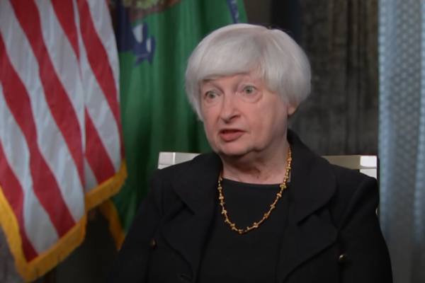 US Treasurer Janet Yellen seated in front of US flag