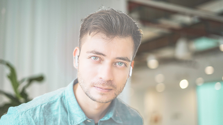 Man with earbuds disappearing into the background