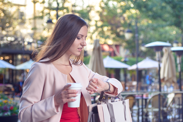 Woman with coffee waiting on someone