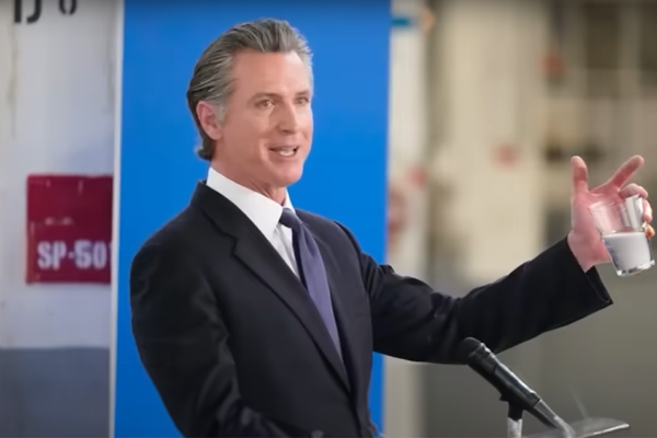 Gavin Newsom holding glass of "water"